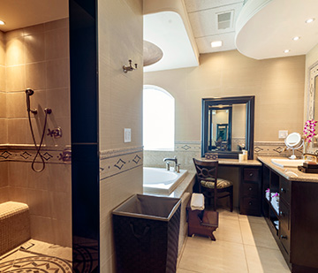 Master suite in Riviera Cancun with shower and tub, includes vanity mirror and hairdryer